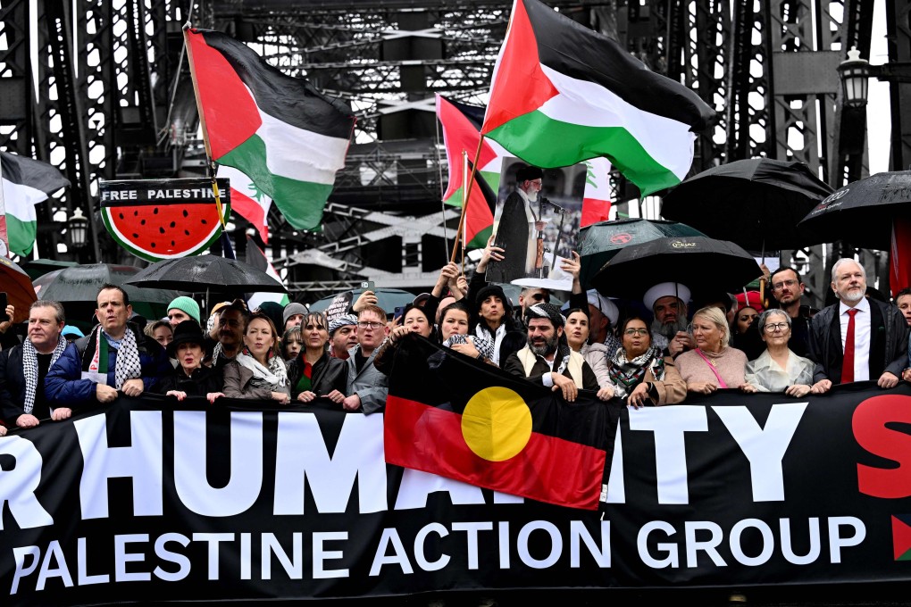 Demonstrators, including WikiLeaks founder Julian Assange (right), cross the Sydney Harbour Bridge during a pro-Palestinian rally against Israel’s actions and the ongoing humanitarian shortages in the Gaza Strip, in Sydney on Sunday. Photo: AFP
