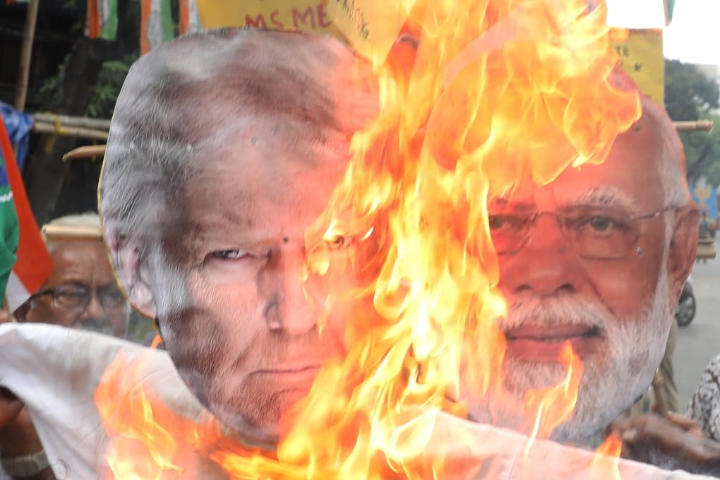 Supporters of India’s main opposition Congress party burn an effigy of US President Donald Trump and Indian Prime Minister Narendra Modi during protest against the US imposing a 25 per cent tariff on all Indian goods. Photo: dpa