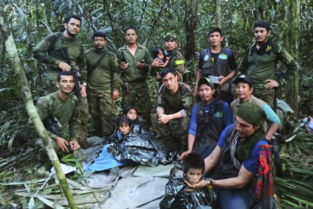 Soldiers and Indigenous men pose for a photo with the four children who were missing after a plane crash, in the Solano jungle, Caqueta state, Colombia on June 9, 2023. The father of the two younger children was on Saturday sentenced to 32 years in prison for sexual abuse. Photo: Colombia’s Armed Force Press Office via AP