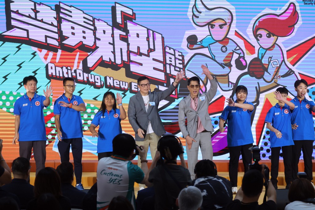 Secretary for Security Chris Tang (third from left) and singer Aaron Kwok (third from right) join youth ambassadors on the stage for a publicity event. Photo: Dickson Lee