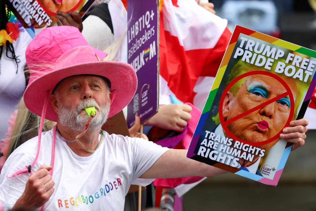 A person holds a sign as boats cruise canals during the annual Pride parade in Amsterdam, Netherlands on Saturday. Photo: Reuters