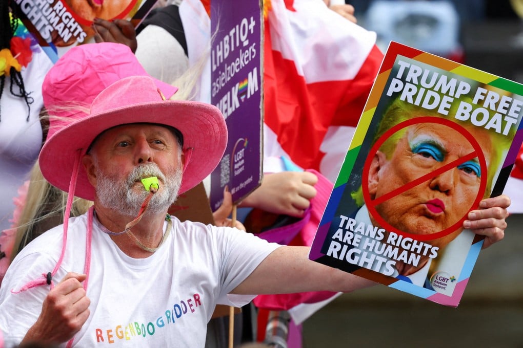 A person holds a sign as boats cruise canals during the annual Pride parade in Amsterdam, Netherlands on Saturday. Photo: Reuters