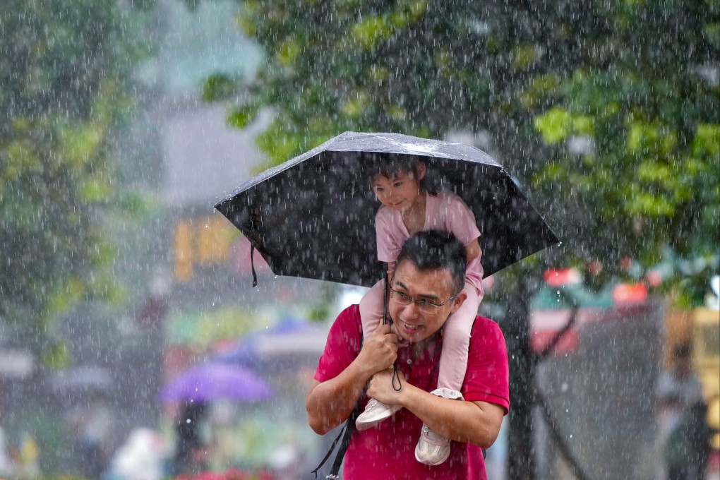 Hong Kong residents brave the heavy rain in Shek Mun on Saturday morning. Photo: Sam Tsang