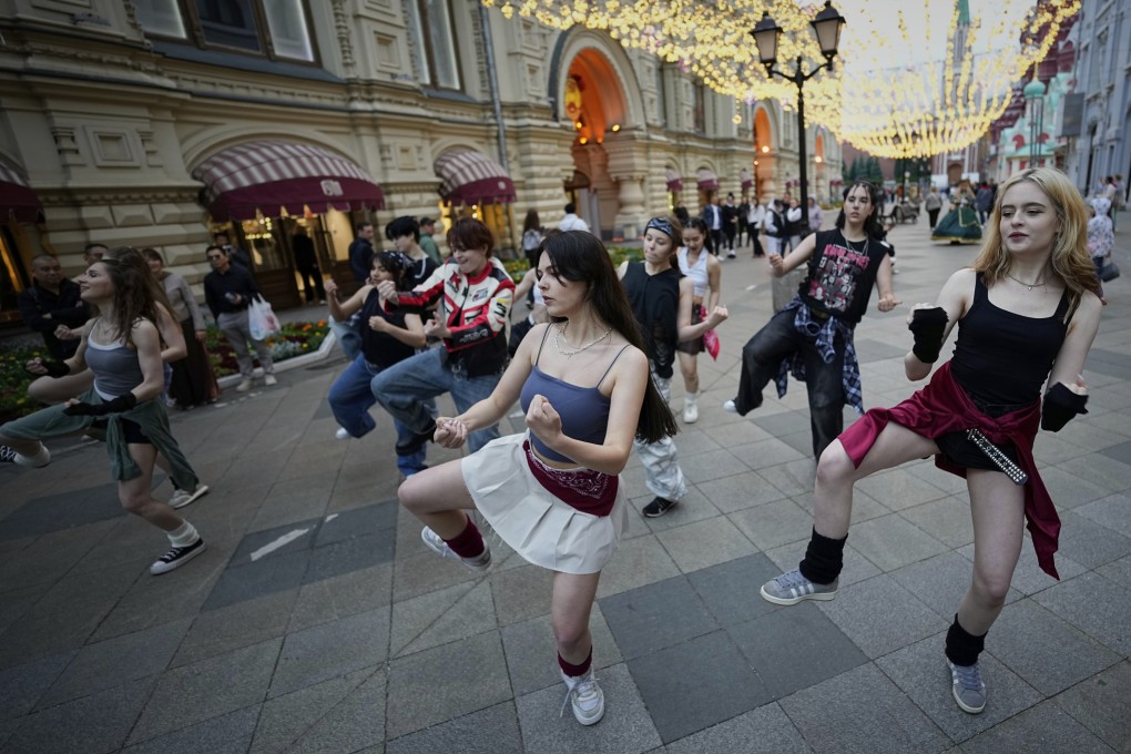 A group of teenagers practise dancing to K-pop music in Nikolskaya Street near Red Square in Moscow on July 1. Photo: AP