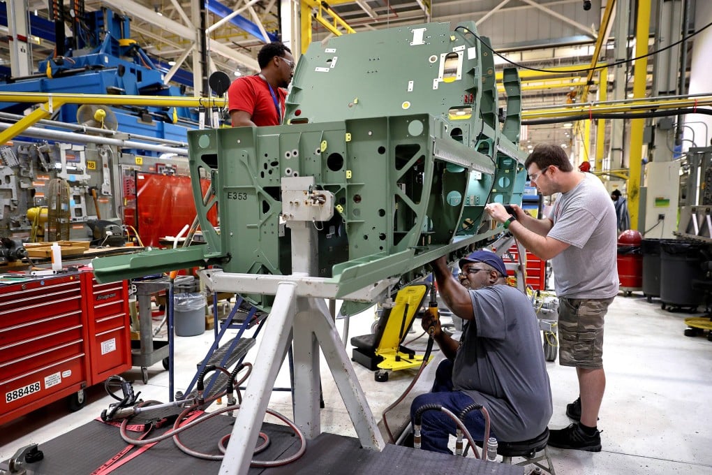 Workers assemble parts on a Boeing F/A-18 Super Hornet fighter jet at the St Louis assembly line. Photo: TNS