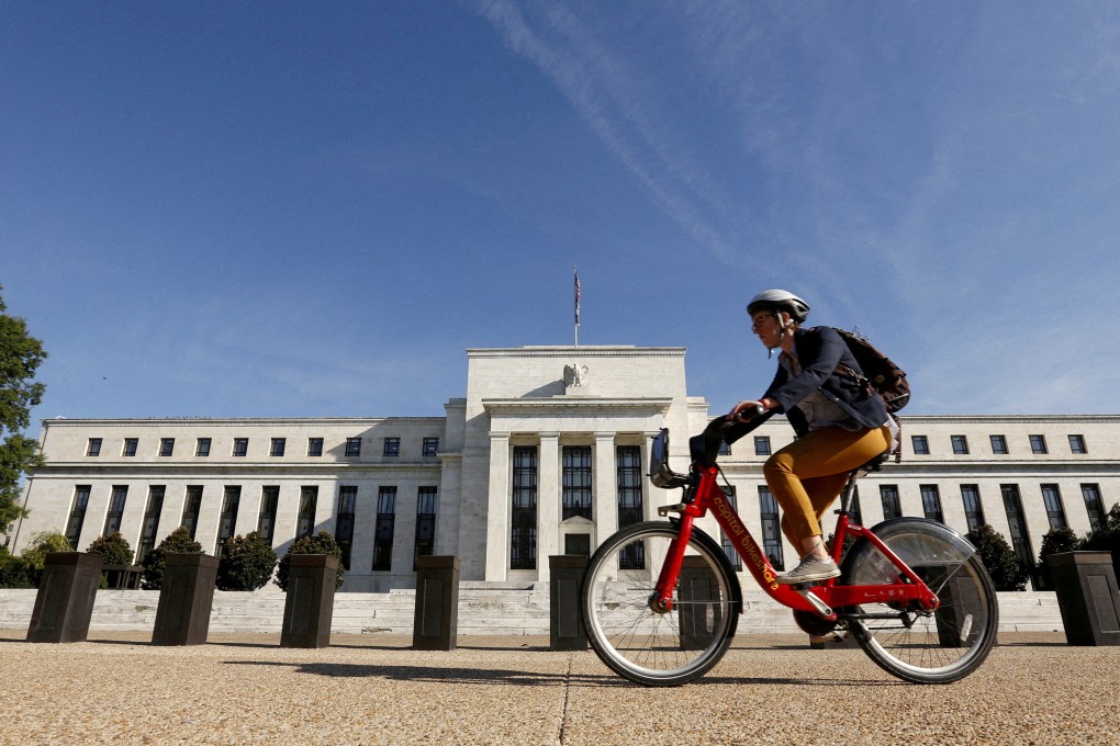A cyclist passes the Federal Reserve headquarters in Washington. Photo: Reuters