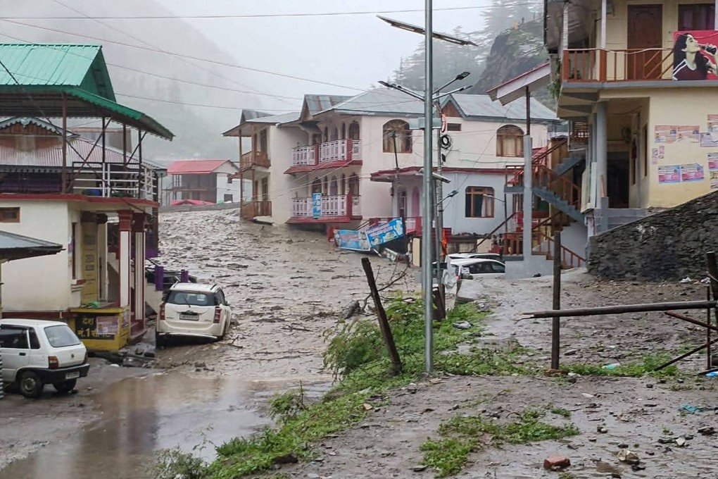 Muddy water runs past residential buildings following a massive mudslide in India’s Uttarakhand state. Photo: Uttarakhand’s State Disaster Response Force/AFP