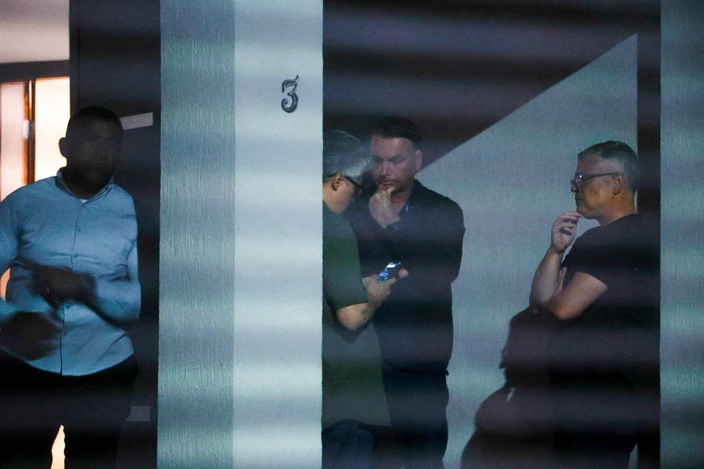 Brazil’s former president Jair Bolsonaro talks to unidentified people at his home after Brazil’s Supreme Court put him under house arrest. Photo: Folhapress via Reuters