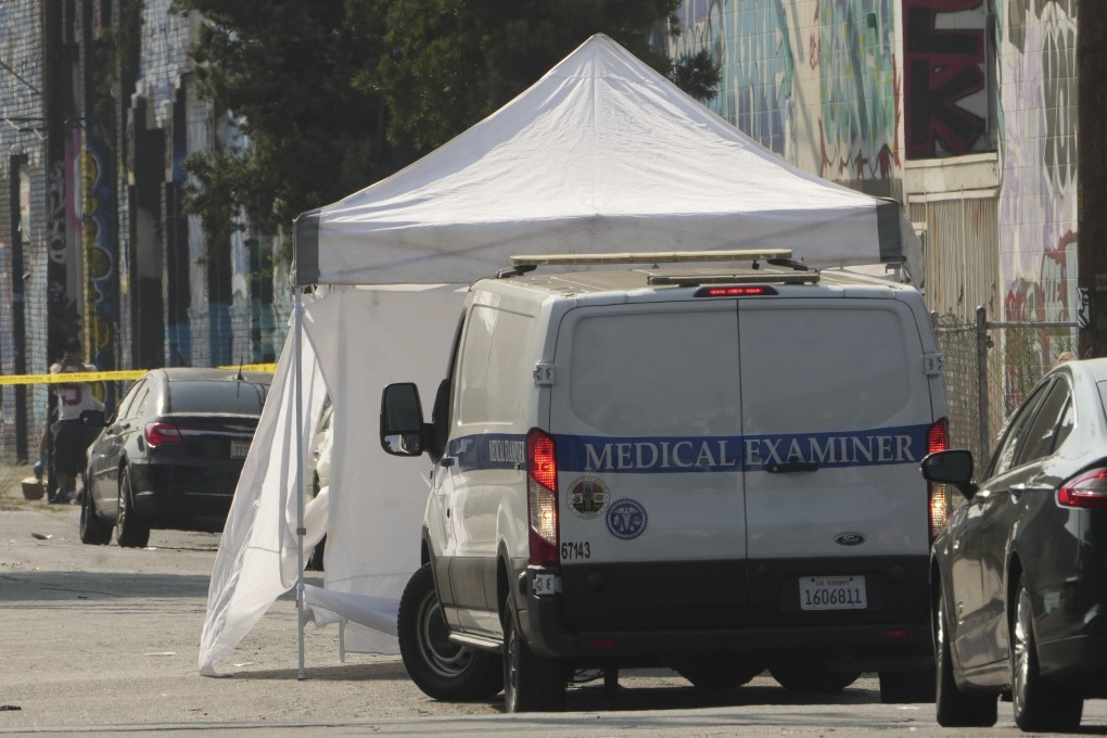 The Los Angeles Coroner Medical Examiner arrives to remove bodies from the scene. Photo: AP