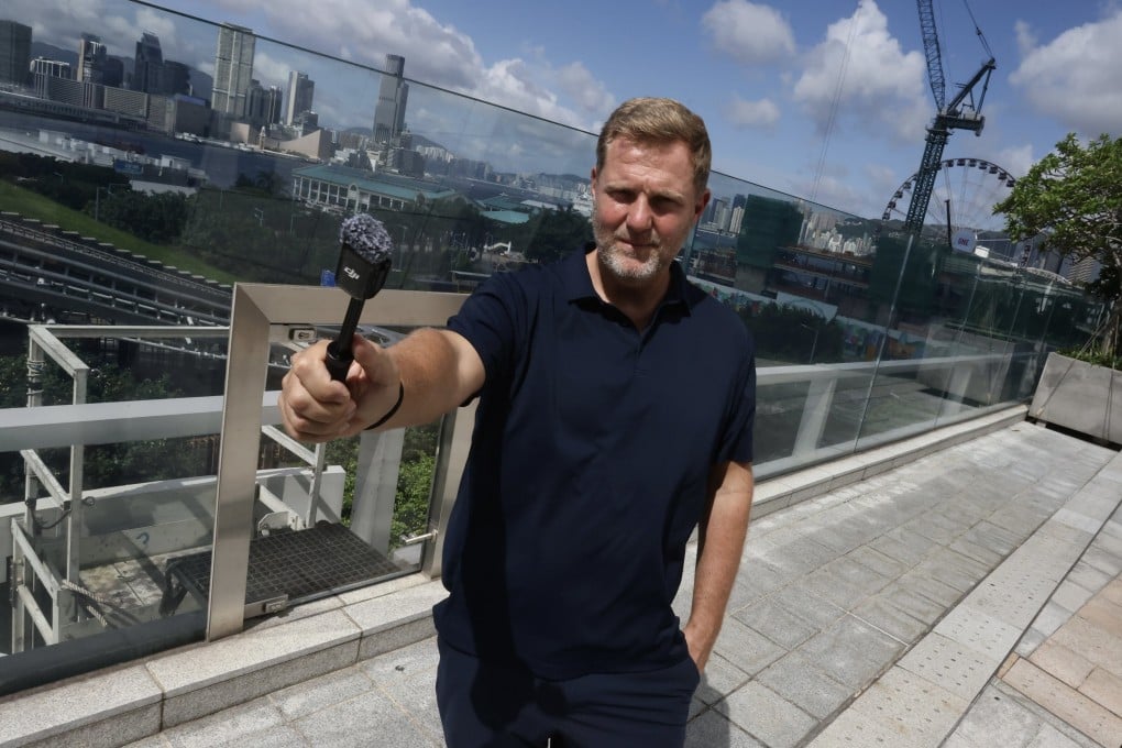 Simon Squibb poses at IFC mall in Hong Kong’s Central neighbourhood. The businessman and content creator talks about expanding his mission to help people escape the “sell your time for money” system. Photo: Jonathan Wong