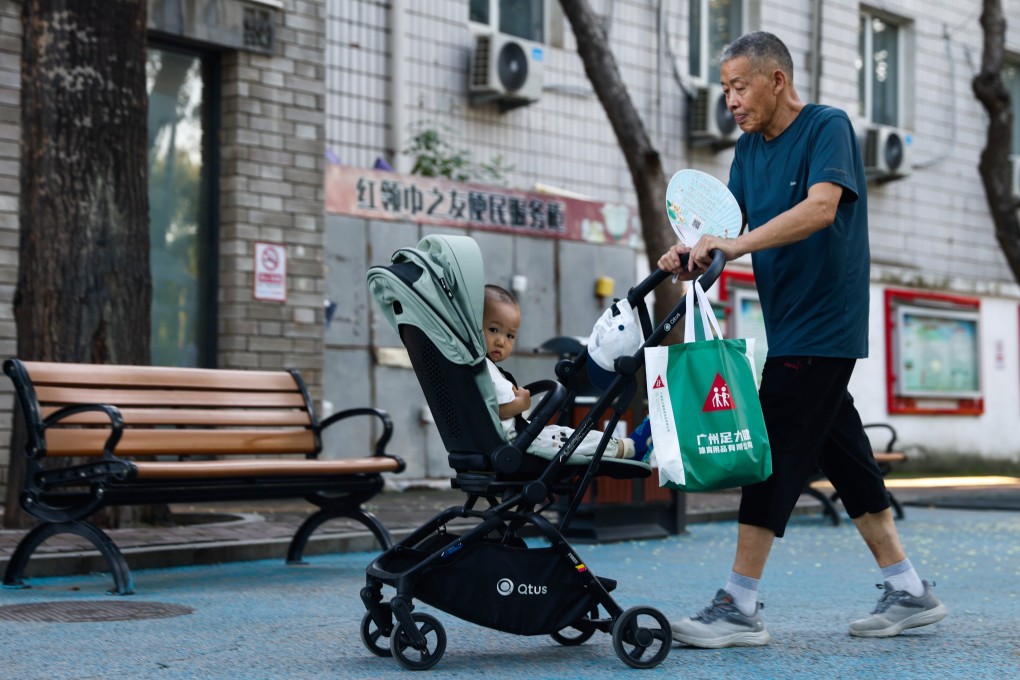 An elderly man pushes a stroller with a child in a park in Beijing on July 30.China’s Ministry of Finance has announced that it will allocate 90 billion yuan (US$12.5 billion) for the initial budget of childcare subsidy payments in 2025. Photo: EPA