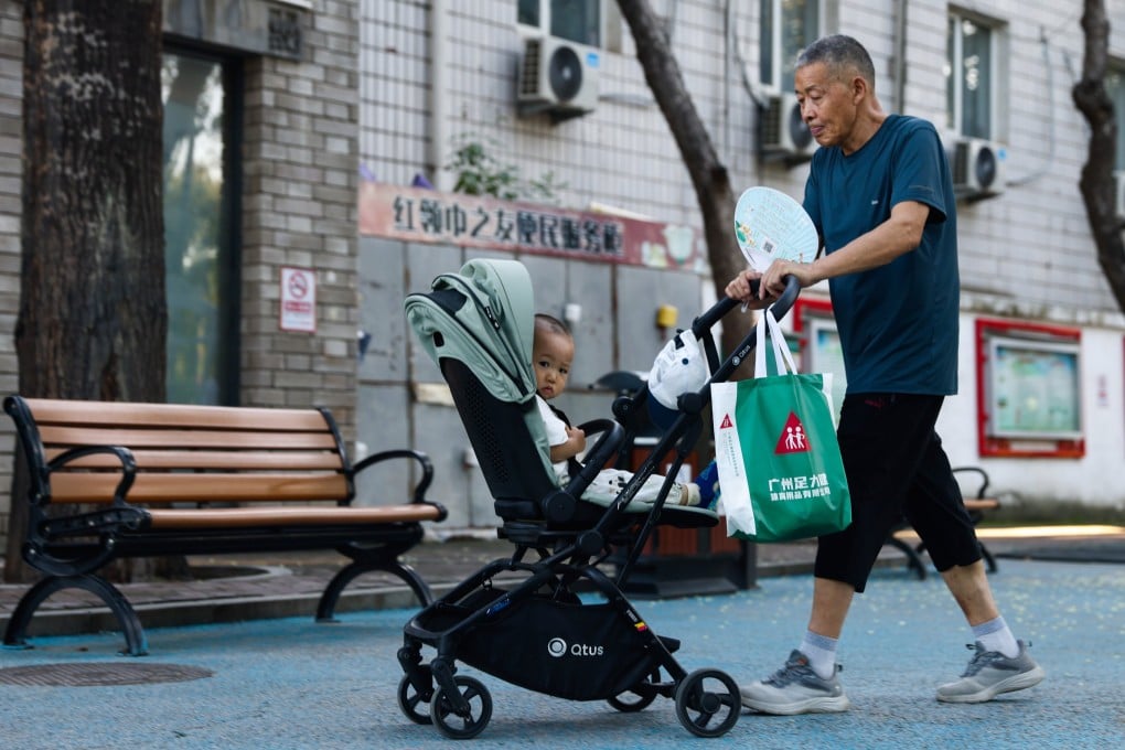 An elderly man pushes a stroller with a child in a park in Beijing on July 30.China’s Ministry of Finance has announced that it will allocate 90 billion yuan (US$12.5 billion) for the initial budget of childcare subsidy payments in 2025. Photo: EPA