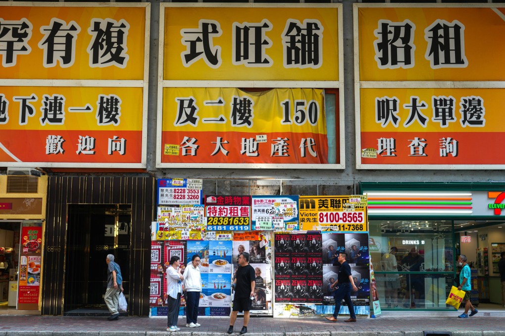 Pedestrians walk under an enormous rental advertisement for a duplex store in Causeway Bay on July 7. Photo: Sam Tsang