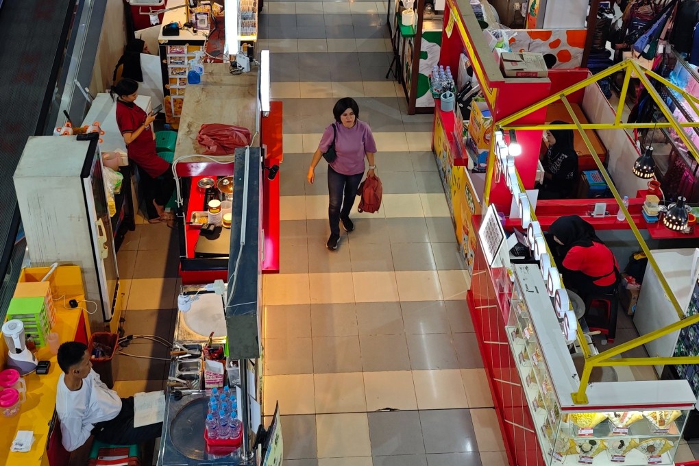 There are more sales people than customers at a shopping centre in  in Depok, Indonesia, on Tuesday. Photo: EPA