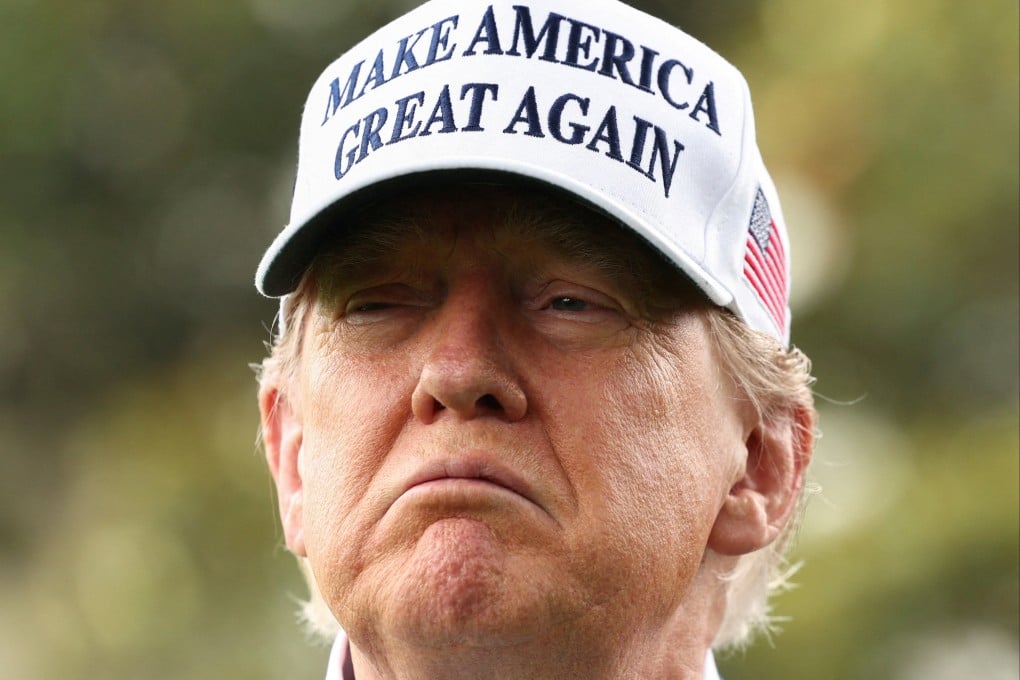 US President Donald Trump wears a Maga cap as he looks on during the installation of a new flagpole at the South Lawn of the White House in Washington on June 18, 2025. Photo: Reuters