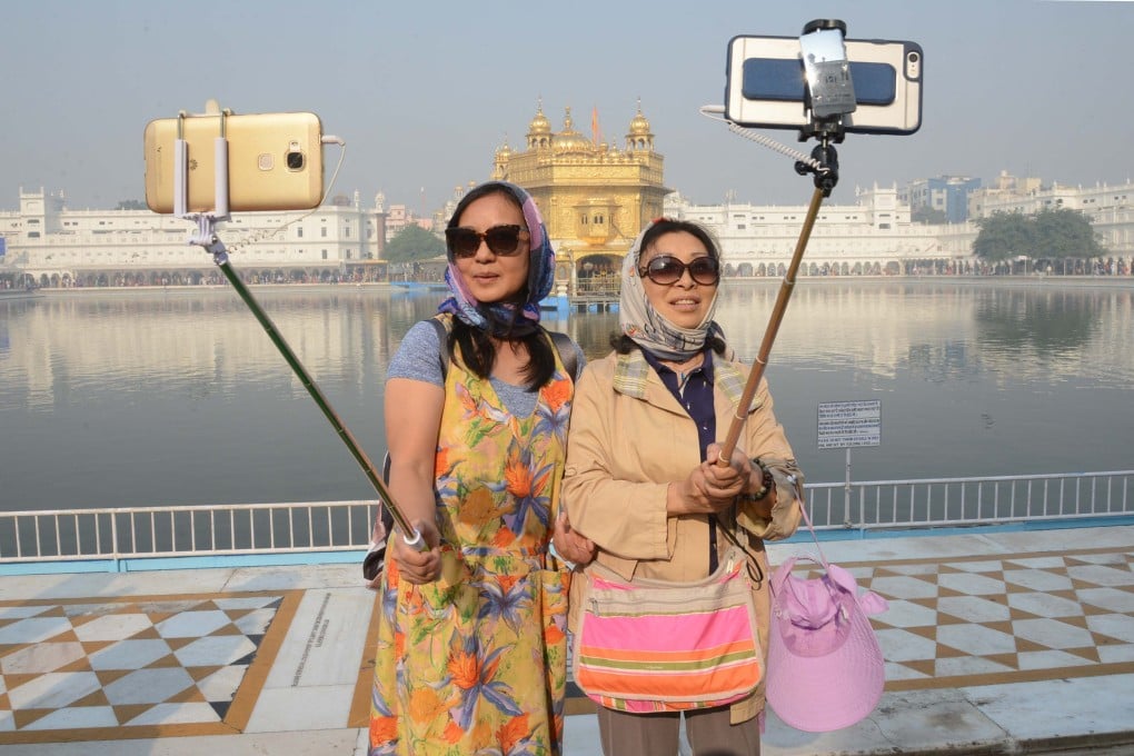 Chinese tourists take a selfie at the Golden Temple in Amritsar. Photo: AFP