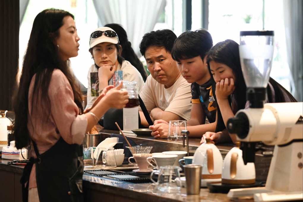 In China, a growing middle class has led to a boom in coffee sales. In the traditional tea-growing Puer area, in China’s southwest Yunnan province, a  staff member pours coffee for guests at the Xiaowazi, or Little Hollow, coffee plantation. Photo: AFP