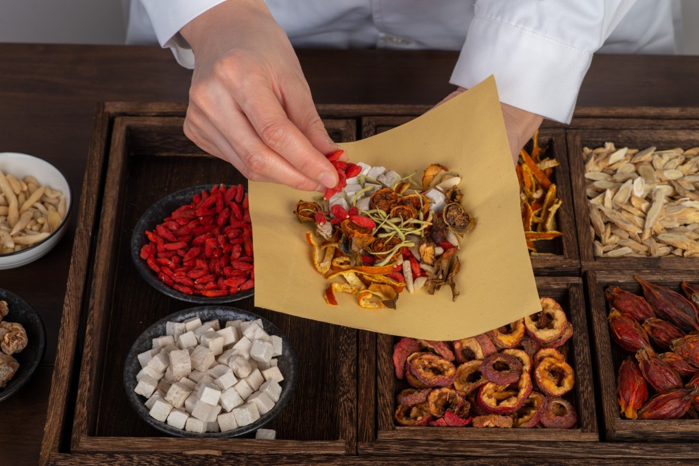 A TCM practitioner prepares traditional Chinese medicine ingredients. Photo: Shutterstock