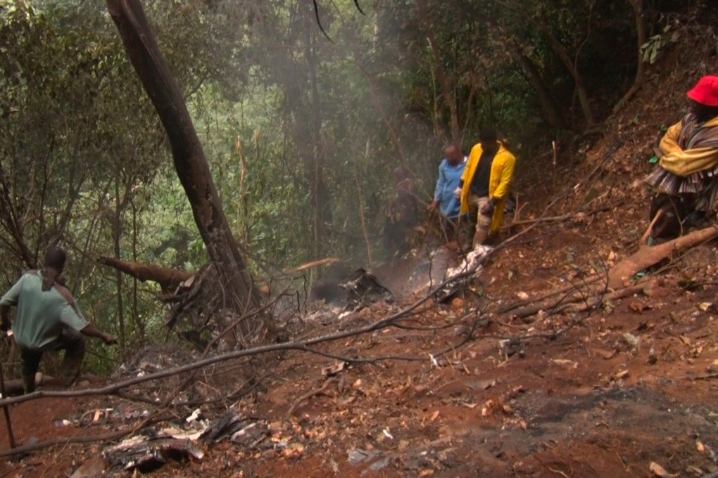 People work at the site of a military helicopter crash in Sikaman near Adansi, in Ghana’s Ashanti region on Wednesday. Photo: AP