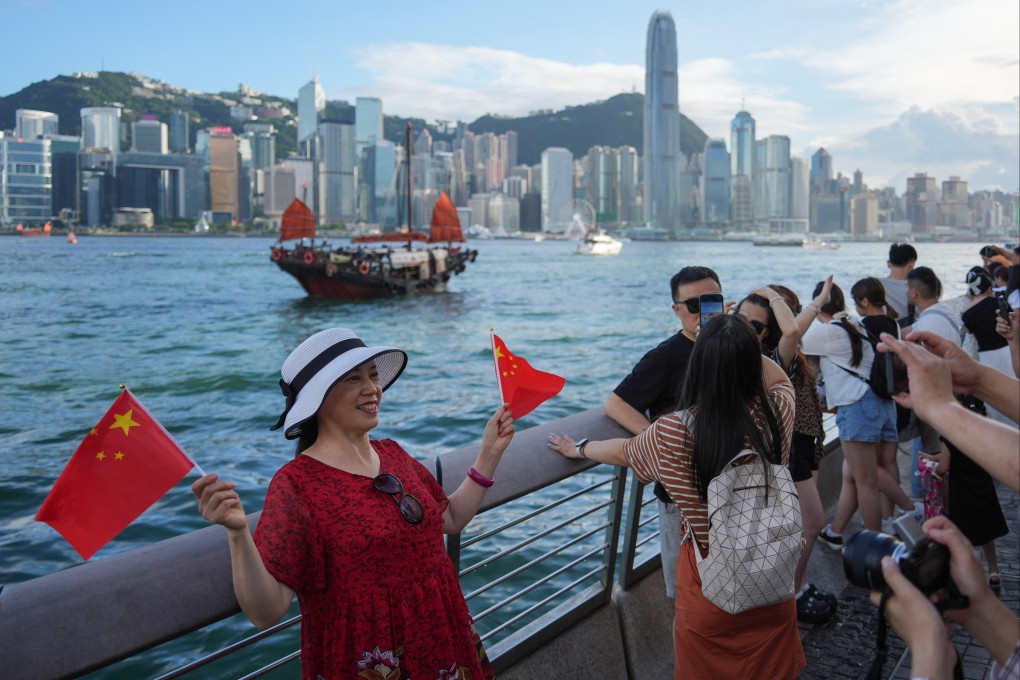 A mainland tourist poses for pictures in Tsim Sha Tsui. Photo: Eugene Lee