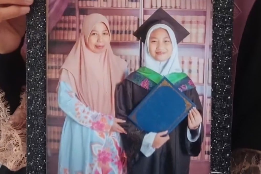 A still from a video circulated on social media shows Zara Qairina Mahathir dressed in academic dress with her mother, Noraidah Lamat. Photo: Facebook