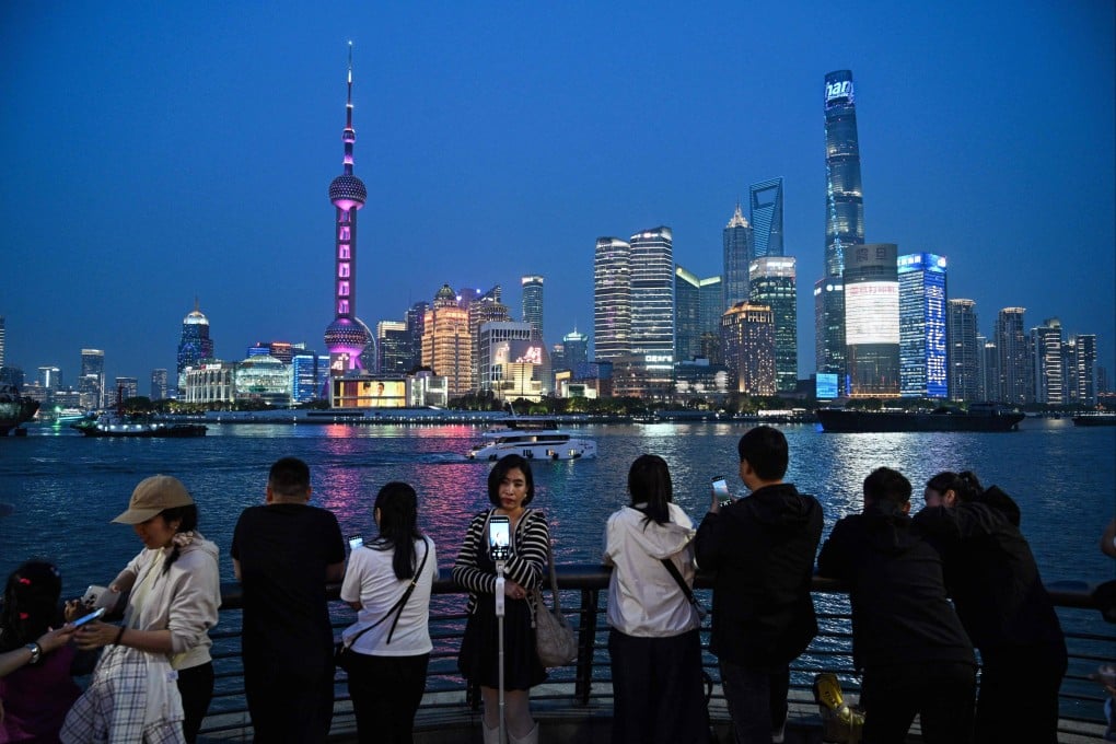 People visit the Bund in Shanghai in April. Photo: AFP
