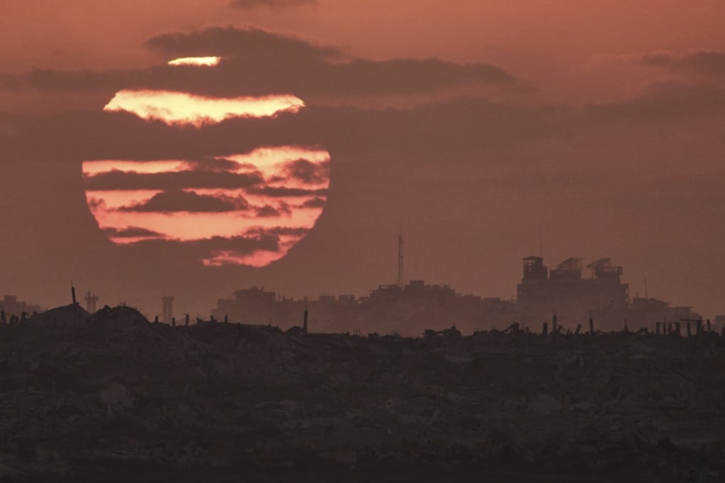 The sun sets on Thursday behind buildings that were destroyed during Israeli ground and air operations in the Gaza Strip. Photo: AP