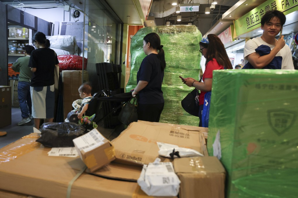 People pick up parcels delivered from across the border at a shop in Hong Kong’s Lok Fu district, on July 23. Photo: Jelly Tse