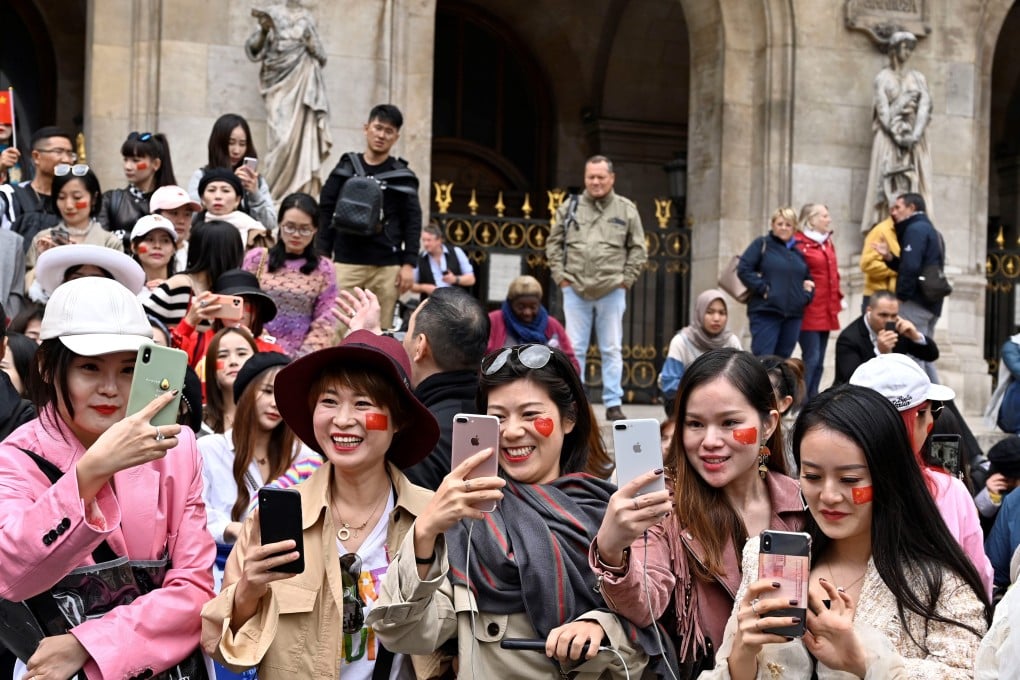 Chinese tourists take selfie in front of Opera Garnier in Paris, France on September 28, 2019. Photo: Anadolu Agency via Getty Images