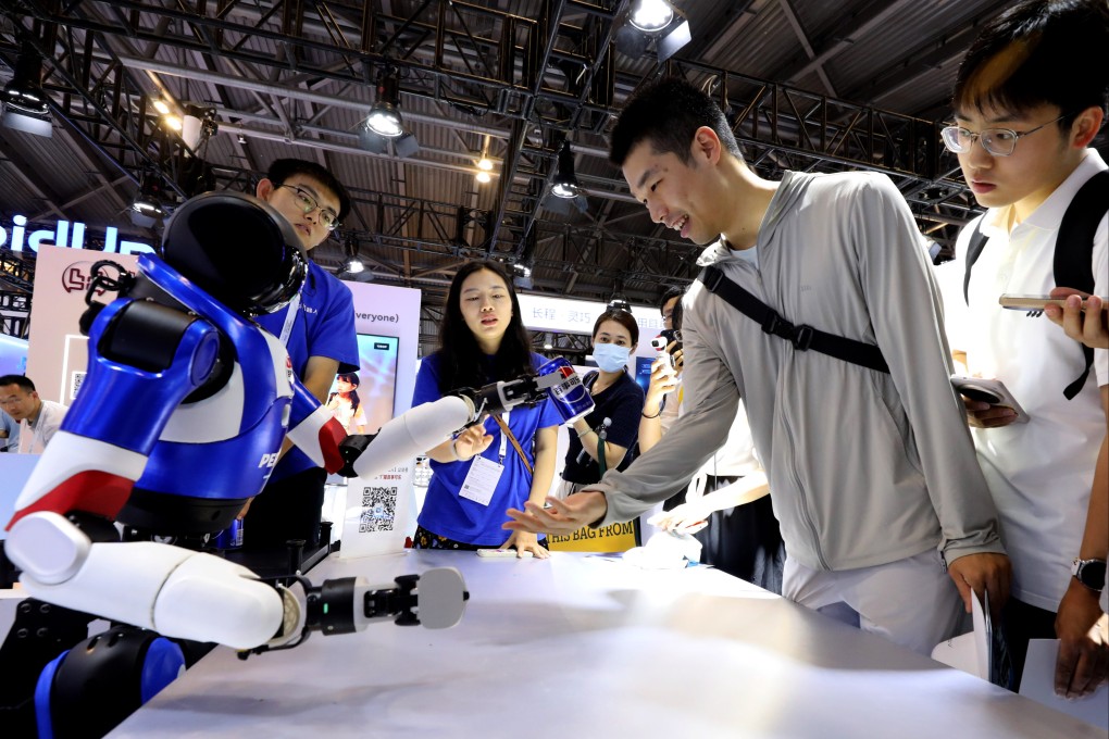 A visitor receives a game prize from a robot at the 2025 World AI Conference in Shanghai on July 29. Photo: Xinhua