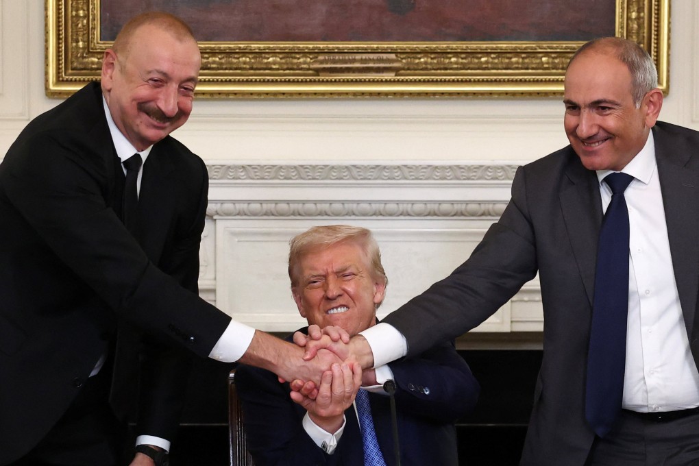 US President Donald Trump holds the hands of Azerbaijan’s President Ilham Aliyev and Armenia’s Prime Minister Nikol Pashinyan during a trilateral signing event at the White House on Friday. Photo: Reuters