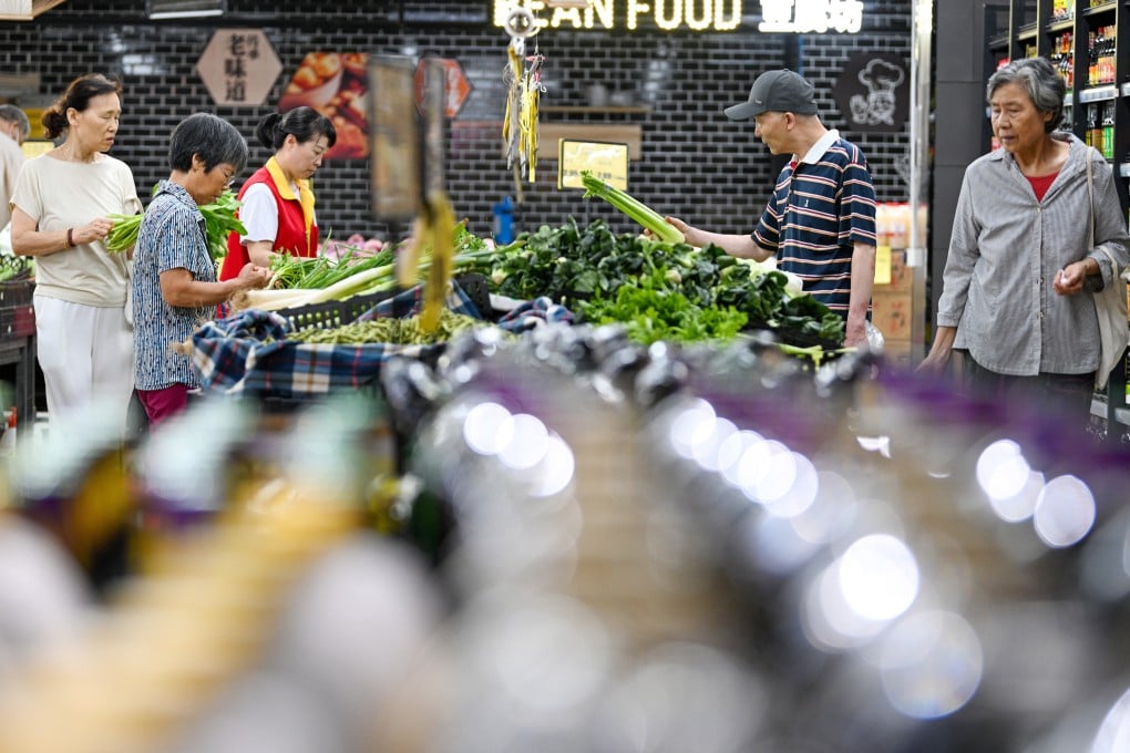 People shop at a supermarket in China’s Jiangsu province. Persistent deflationary pressures have been weighing on consumer prices across the country. Photo: Xinhua