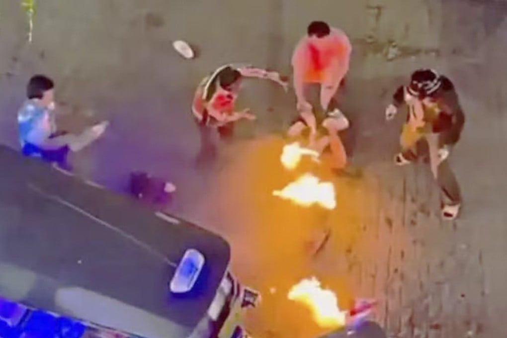 A screengrab from a social media video shows the two Malaysian tourists being set on fire in front of the Big C shopping centre in Bangkok. Photo: Handout