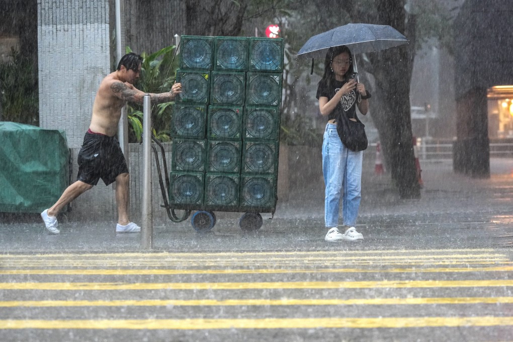 People brave the weather in Central, Hong Kong, during a black rainstorm alert on July 29. Photo: May Tse
