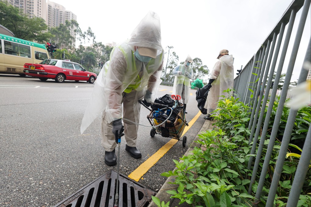 Workers from the Food and Environmental Hygiene Department carry out mosquito control efforts near On Tat Estate in Kwun Tong. Photo: Dickson Lee