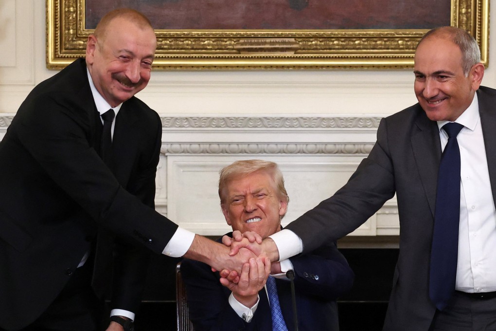 US President Donald Trump holds the hands of Azerbaijan’s President Ilham Aliyev and Armenia’s Prime Minister Nikol Pashinyan during a trilateral signing event on Friday. Photo: Reuters