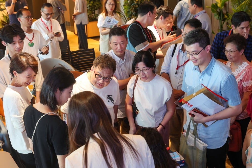 Potential buyers and estate agents talk at the sales venue for the 33 Kennedy Road project in Quarry Bay on August 10, 2025. Photo: Edmond So