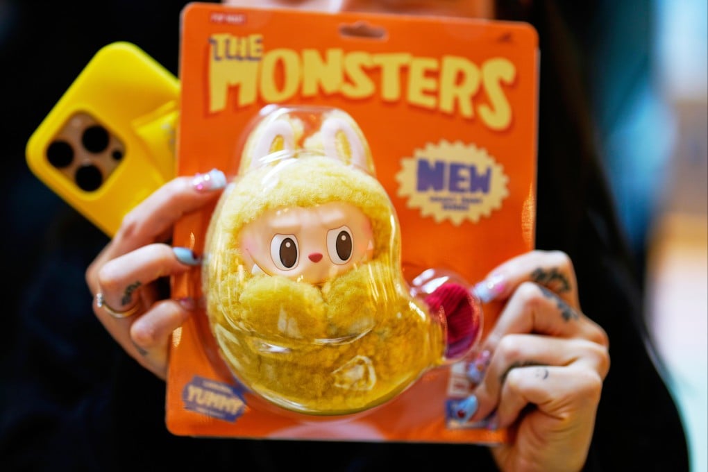 A customer shows off a new Labubu during the opening of Germany’s first shop for the dolls in Berlin in July. Photo: AP