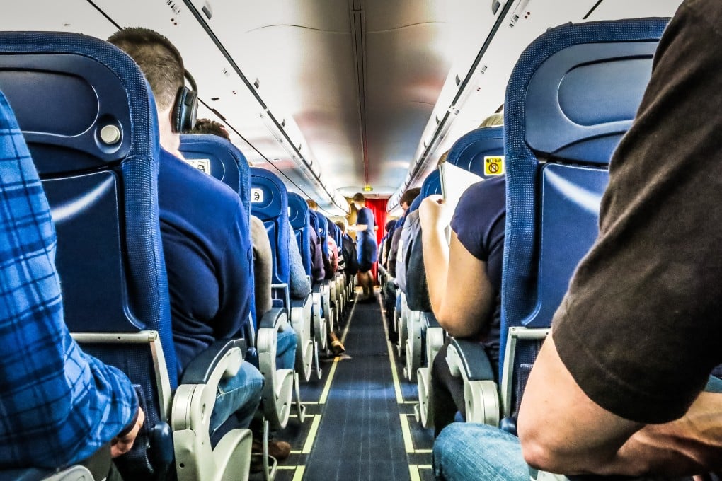Rear View Of People Sitting In Airplane