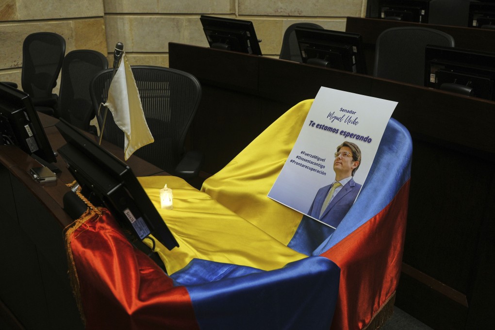 A leaflet showing Colombian Sen. Miguel Uribe Turbay sits on a Colombian national flag draped over his seat in the congressional chamber in Bogota, Colombia in June. Photo: AP
