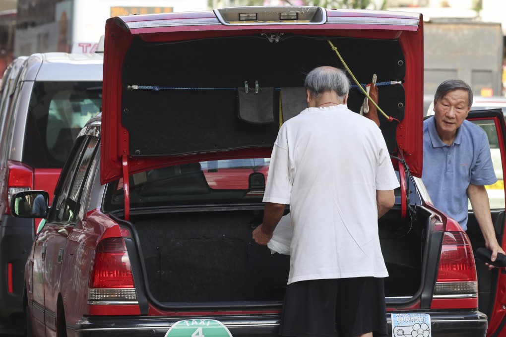 Elderly taxi drivers clean their vehicles at a depot in Prince Edward. Photo: Jelly Tse