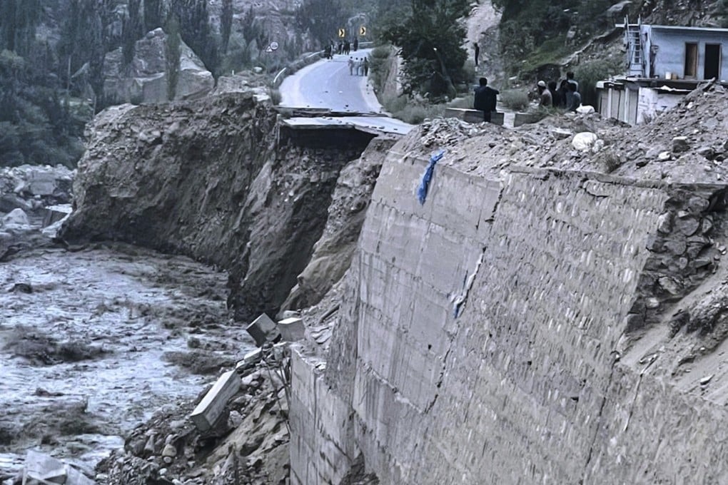 Local residents look a damaged portion of Karakoram Highway following a flash flood triggered by a glacial lake outburst in northern Pakistan on Sunday. Photo: AP