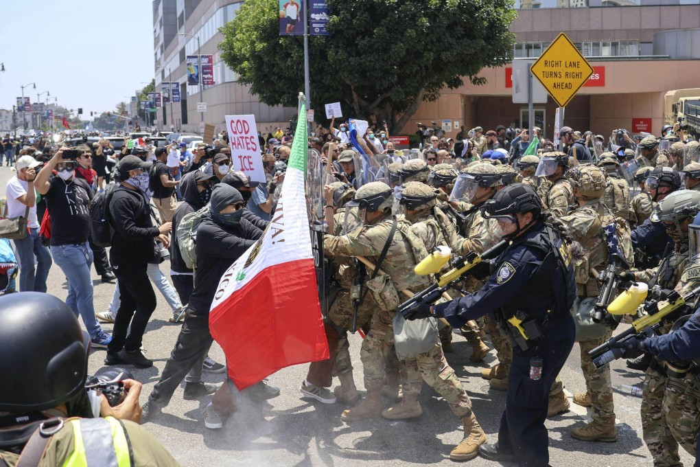 National Guard troops and other law enforcement clash with demonstrators in Los Angeles on June 8. Photo: Kyodo