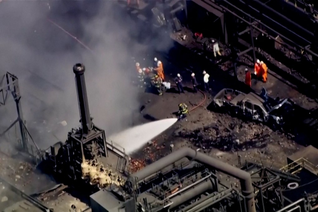 Firefighters spray water after the explosion. Photo: WTAE via Reuters