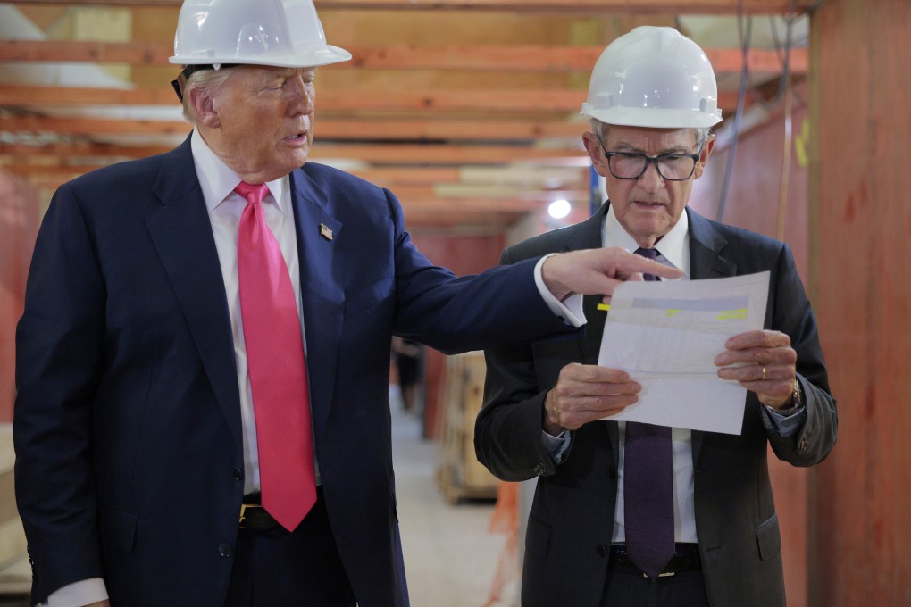 US President Donald Trump presents Federal Reserve Chair Jerome Powell with what Trump called a list of cost overruns for the Federal Reserve’s renovation project on July 24. Photo: TNS