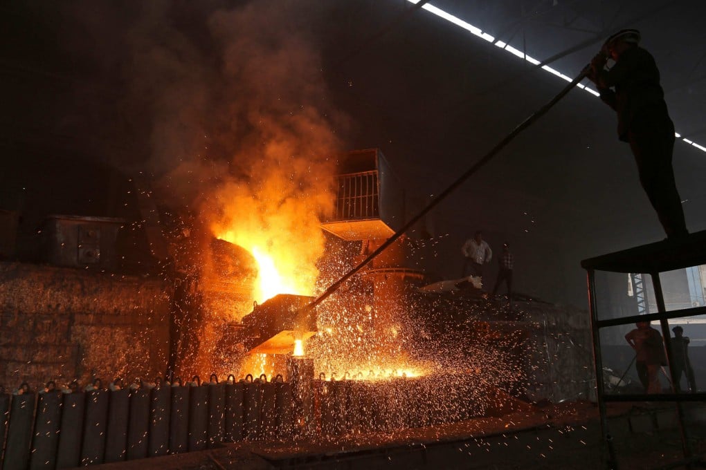 A labourer works inside a steel factory in Jammu, India, earlier this year. Photo: AFP
