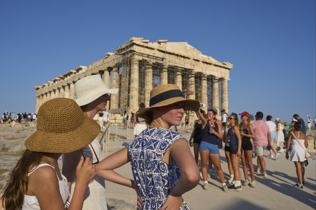 Tourists visit Greece’s Acropolis during a heatwave in Athens on July 25, 2025. More travellers are avoiding visiting places in Europe in summer that suffer from extreme weather, instead opting to travel during the “shoulder season”. Photo: AP
