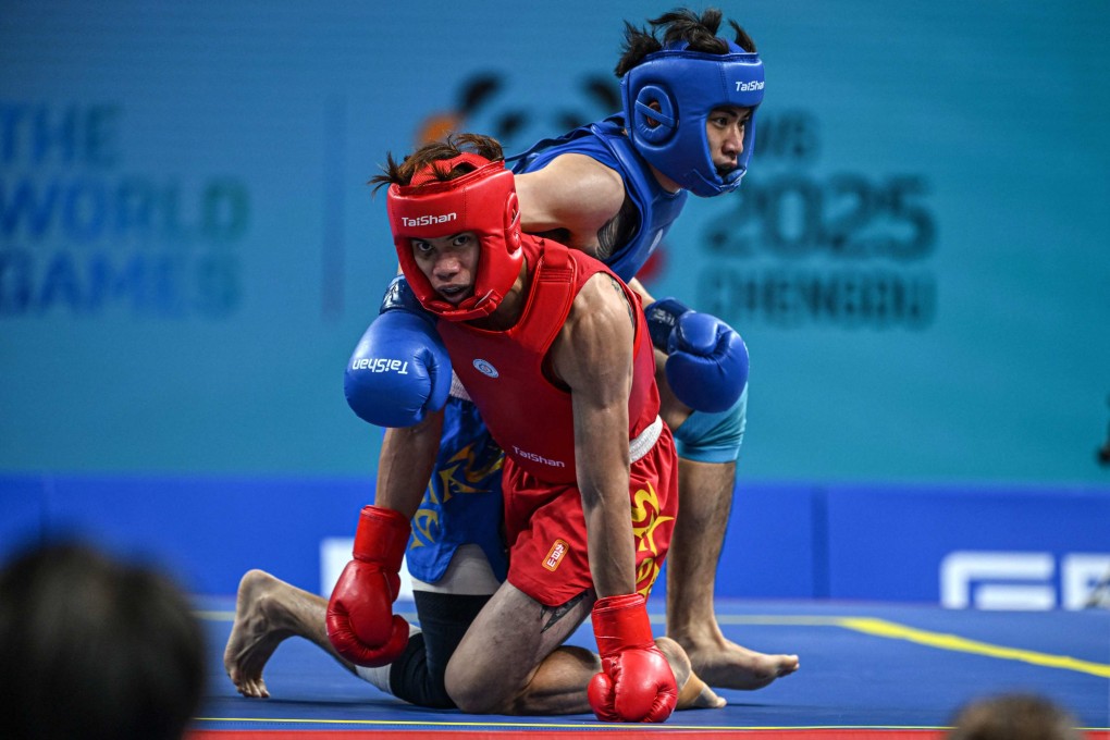 Cheung Yat-lam (red) during his wushu 70kg semi-final win over Chinese Taipei’s Zhang Huan-yi in Chengdu. Photo: AFP