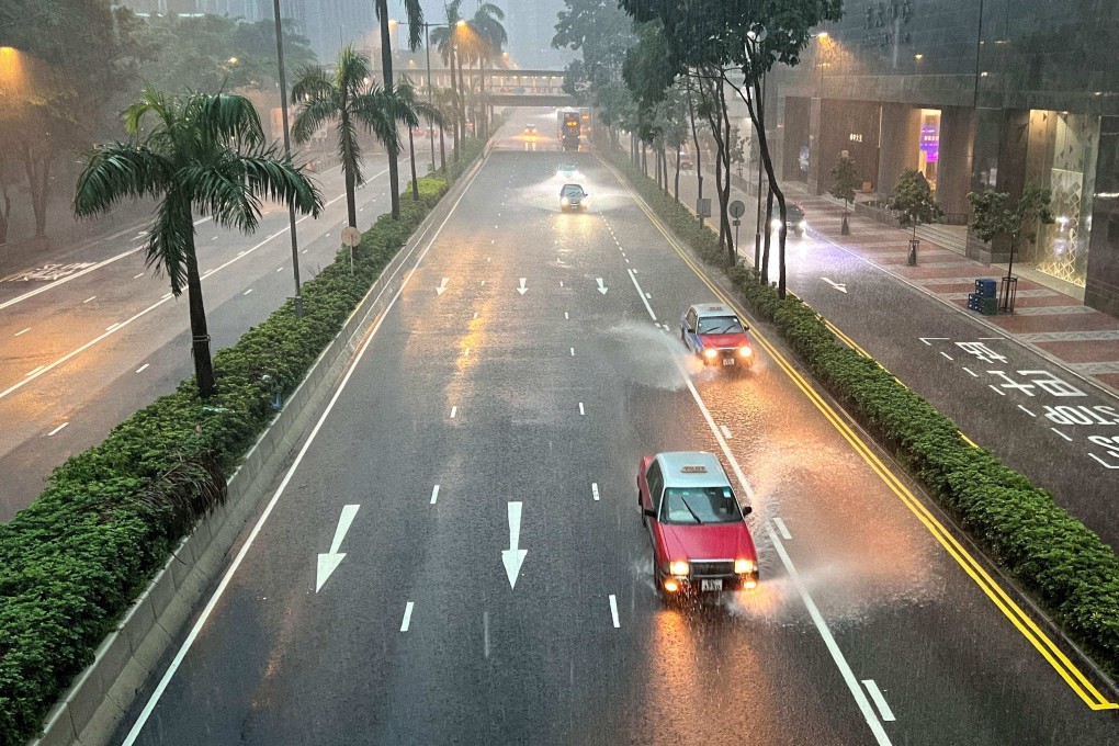 Taxis and other vehicles drive along a waterlogged Gloucester Road in Wan Chai district on August 5. Hong Kong currently requires drivers “to read at a distance of 23m in good daylight a vehicle number plate”. Photo: AFP