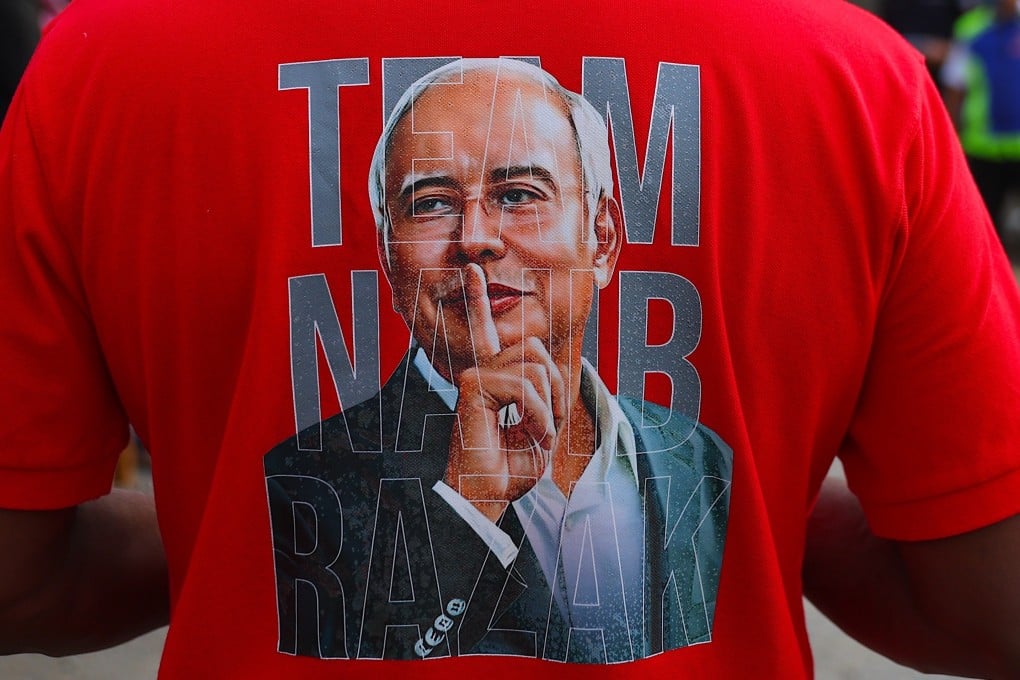 A supporter of Najib Razak wears a T-shirt displaying the former prime minister’s face outside the Federal Court in Putrajaya, Malaysia, on Wednesday. Photo: EPA